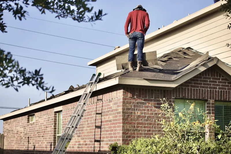 Professional roofer working on a residential roof in Roseburg